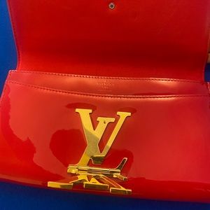Red patent leather Louis Vuitton clutch